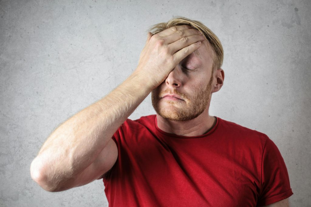 Man holding his head from a headache